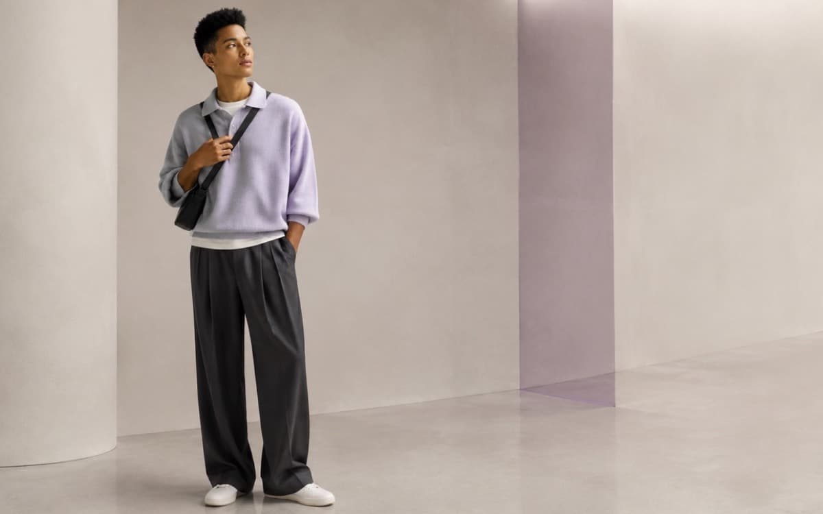 Young adult in a lilac top and relaxed charcoal trousers in the Modiq studio