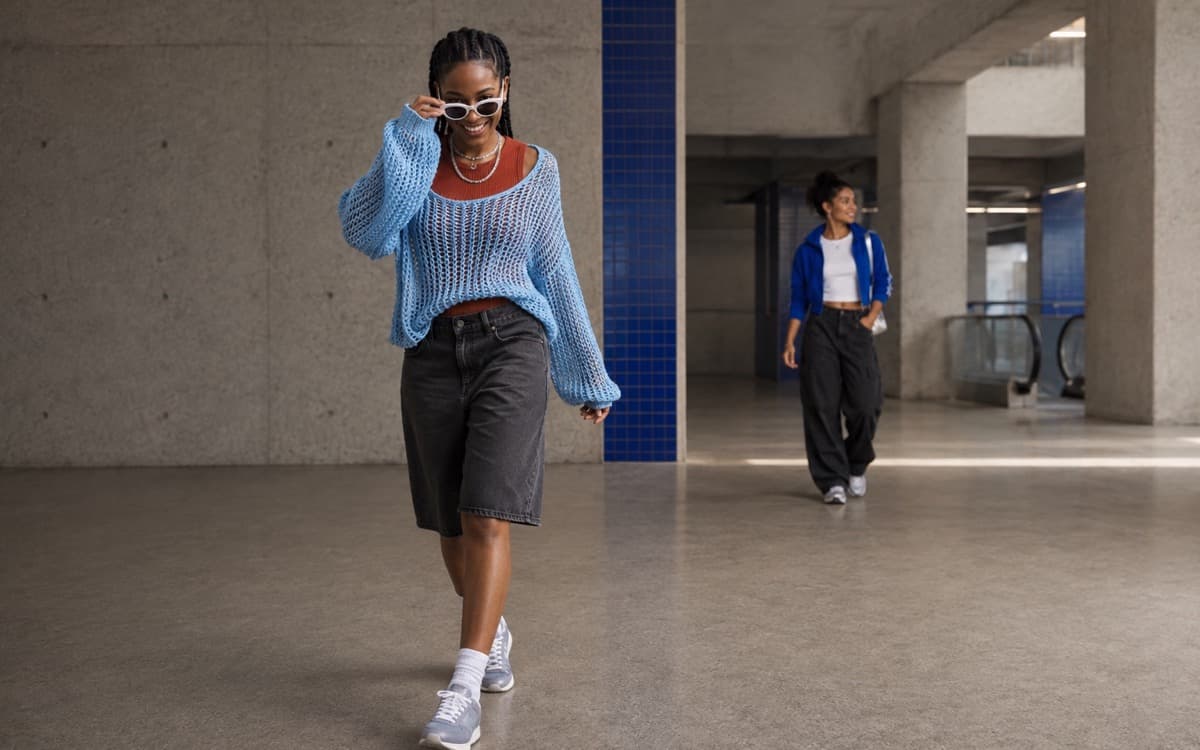 Young adult in a colorful open-knit layer and relaxed denim in the Modiq studio